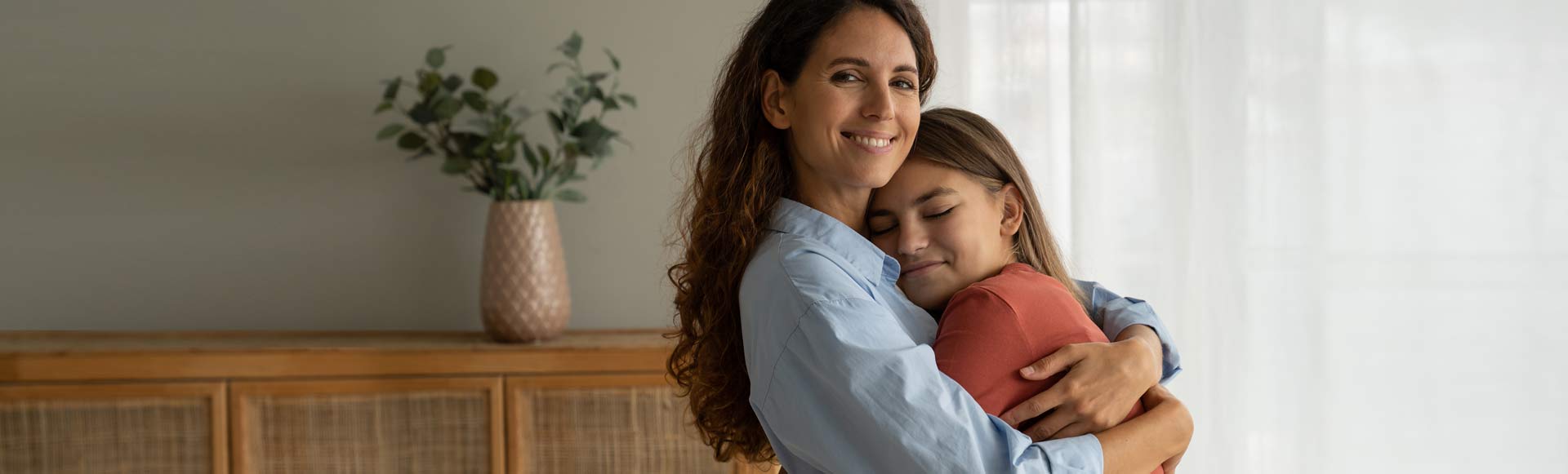 Woman and girl hugging